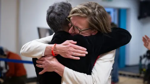 Getty Images Labour candidate Catherine Fookes hugs a supporter after winning the Monmouth constituency