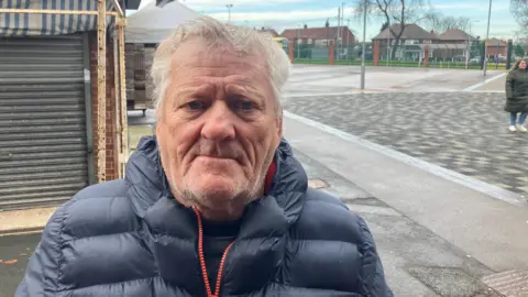 Photograph of Martin Byron from Wythenshawe. He is pictured at Wythenshawe Civic Centre.