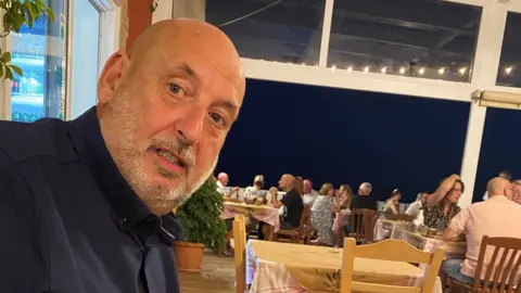 Headway A man in a black shirt looking at the camera