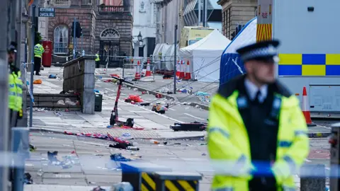 PA Media Police tents surrounded by debris at the scene in Water Street near the Liver Building in Liverpool city centre after 