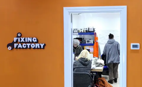 BBC Volunteers repair electrical items at the Fixing Factory in Camden, London