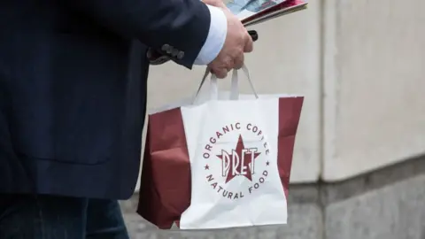 Man carrying bag of Pret food