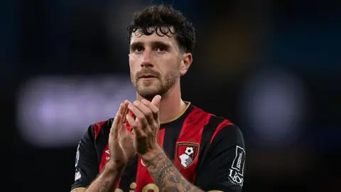 Marcos Senesi applauds Bournemouth fans after a game at Manchester City in November 2025