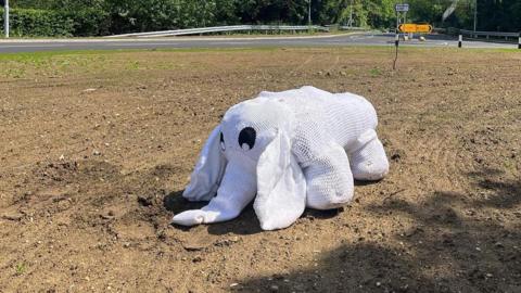 A knitted white elephant on a roundabout