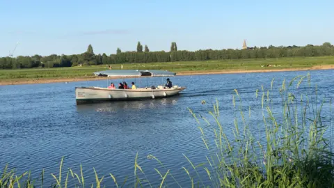 hornist TUESDAY - A sightseeing boat on the river at Summertown