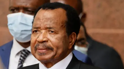 Paul Biya in black suit and white shirt