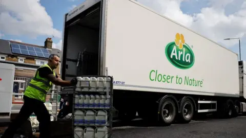 Getty Images A man delivers milk next to an Arla lorry