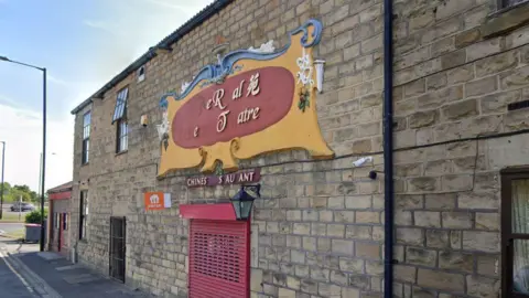 The outside of the former Royal Electric Theatre. Several letters are missing from the sign, which should read The Royal Electric Theatre.