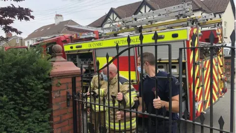 South Wales Fire and Rescue firefighters at the gate