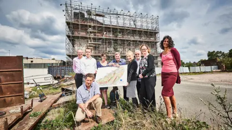 Cucumber PR People standing in front of a building with scaffolding