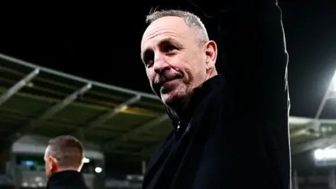 John Cartwright looking up to the stand waving after his final game in charge of Hull