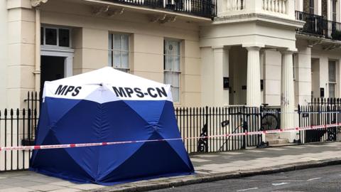 A Met Police tent, often used at crime scenes, has been erected on Taviton Street