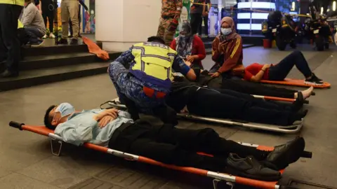 EPA Healthcare workers treating injured passengers in the train station