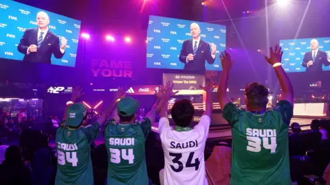 Saudi Arabia fans wave as Gianni Infantino makes a speech
