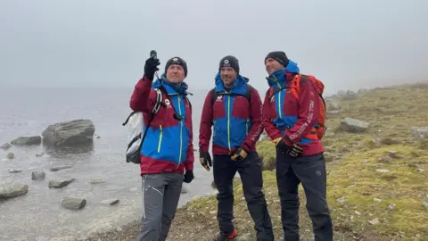 Lake District National Park Authority Fell Top Assessors Jim Evans, Zac Poulton and Paddy Cave measure wind speed and temperature on the first day of the winter season launch 2024