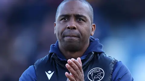 Darren Byfield applauds fans after a Walsall match