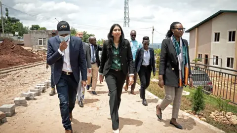 PA Media Then-Home Secretary Suella Braverman tours a building site on the outskirts of the Rwandan capital, Kigali, where asylum seekers deported from the UK could be housed