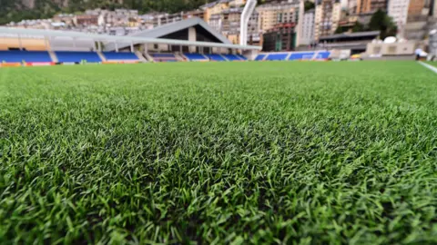 PA A close of shot of fake grass on an artificial pitch