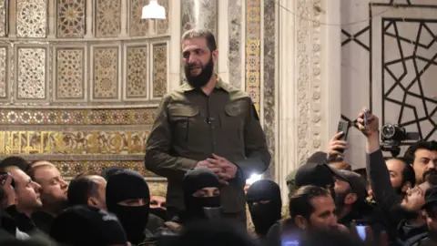 Getty Images Abu Mohammed al-Jolani addresses a crowd inside the Umayyad Mosque in Damascus