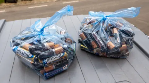 Getty Images Two clear bags full of batteries