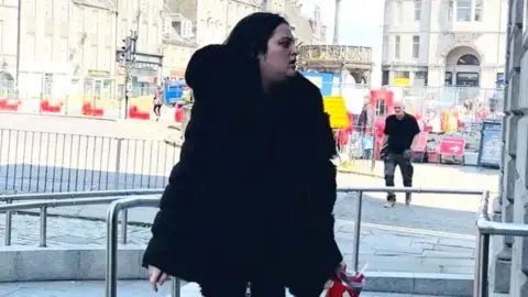 Courtney Gartshore, dressed in black, arrives at the High Court in Aberdeen.