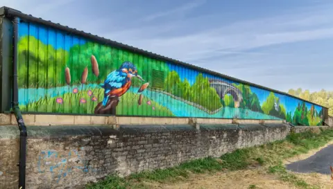 Stuart Harrison Wedding Photography A mural showing a kingfisher bird in front of a river and a bridge