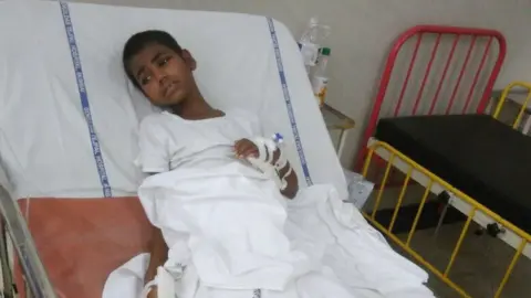 Mayuresh Konnur Ravita Walvi lying on a bed in the hospital