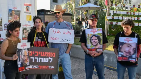 Getty Images Friends and families of hostages demonstrate in Tel Aviv - 16 December