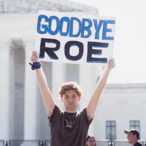 Students for Life Person holding 'Goodbye Roe' sign