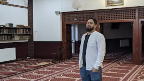 man standing in Mosque