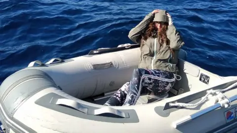 Hellenic Coast Guard Kushila Stein in her rubber dinghy after being rescued by the Hellenic Coast Guard