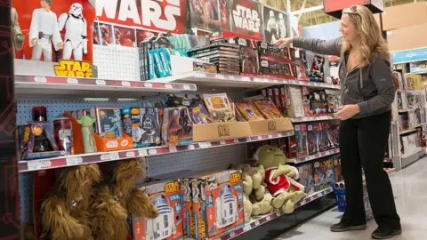 The Washington Post/Getty Images Woman looking at Star Wars toys