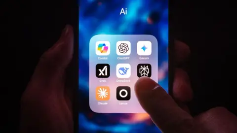 A person's finger hovers over a phone screen, displaying several AI app widgets including copilot, chatgpt, gemini and grok.
