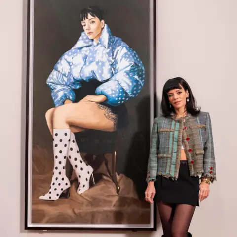 National Portrait Gallery Lily Allen standing in front of her portrait at the National Portrait Gallery