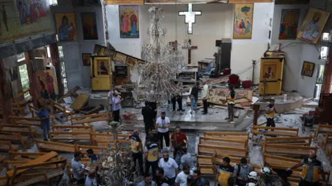 EPA People inspect damage following a suicide bomb attack at the Mar Elias Church in Dweila, a suburb of Damascus, Syria (22 June 2025)