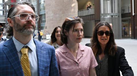 Amanda Knox arriving at a courthouse in Florence with her husband and a lawyer