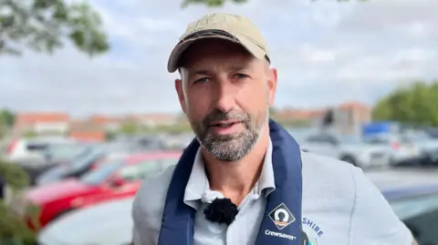 Matt Arnold from East Yorkshire Rivers Trust. He is wearing a grey polo shirt and a beige baseball cap.