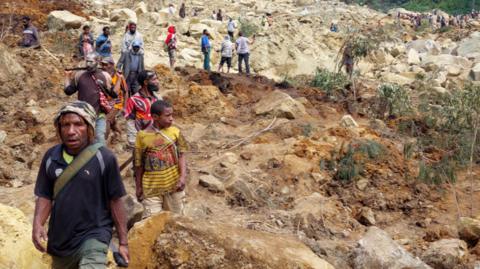 Locals gather at the site of a landslide in Papua New Guinea's Enga Province on May 26, 2024.