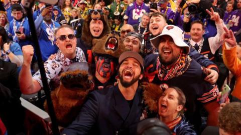 Caleb Williams takes a selfie with Bears fans after picking announced as the number one pick