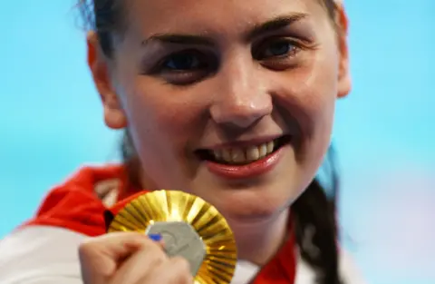 Reuters A young woman with a gold medal