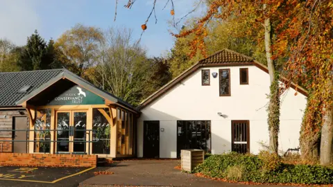 The Hawk Conservancy Trust The exterior of the trust building, set among a forested area.