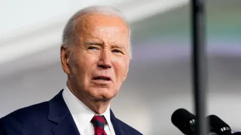 Reuters Joe Biden delivers remarks at a lectern