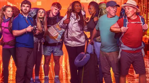 BBC/Studio Lambert/Gary Moyes A promotional image where the cast of Race Across The World series 5 are stood together on a damp street