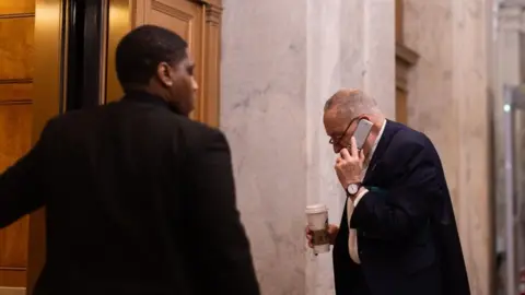 EPA US Senate Minority Leader Chuck Schumer (R) enters the US Capitol with an impending government shutdown looming on 14 March