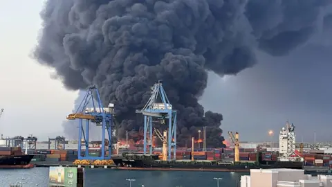 Smoke rises after explosions at South Port of the city of Port Sudan.