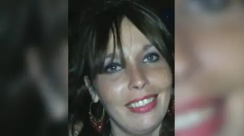 West Yorkshire Police/Family handout A smiling woman looking at the camera with long, dark hair and wearing hooped earrings. 