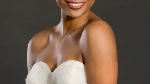 A model poses in a white wedding dress. Stock photo from archive.