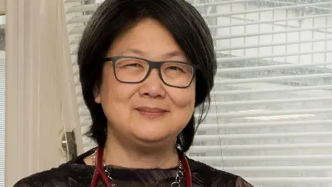OUH Prof Ling-Pei Ho has medium length black hair and is wearing a black top, with a stethoscope around her neck.