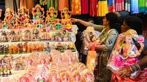 Getty Images People buy idols of Hindu goddess Lakshmi and other gods at a market in Hyderabad