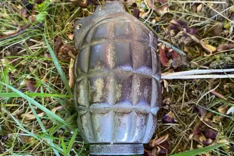 Supplied Grenade lying on grass at school